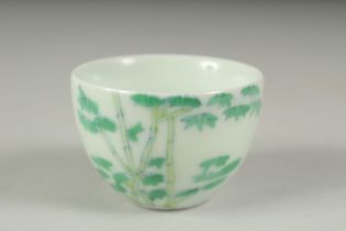 A CHINESE FAMILLE VERTE PORCELAIN CUP, decorated with bamboo, character mark to base. 6cm diameter.