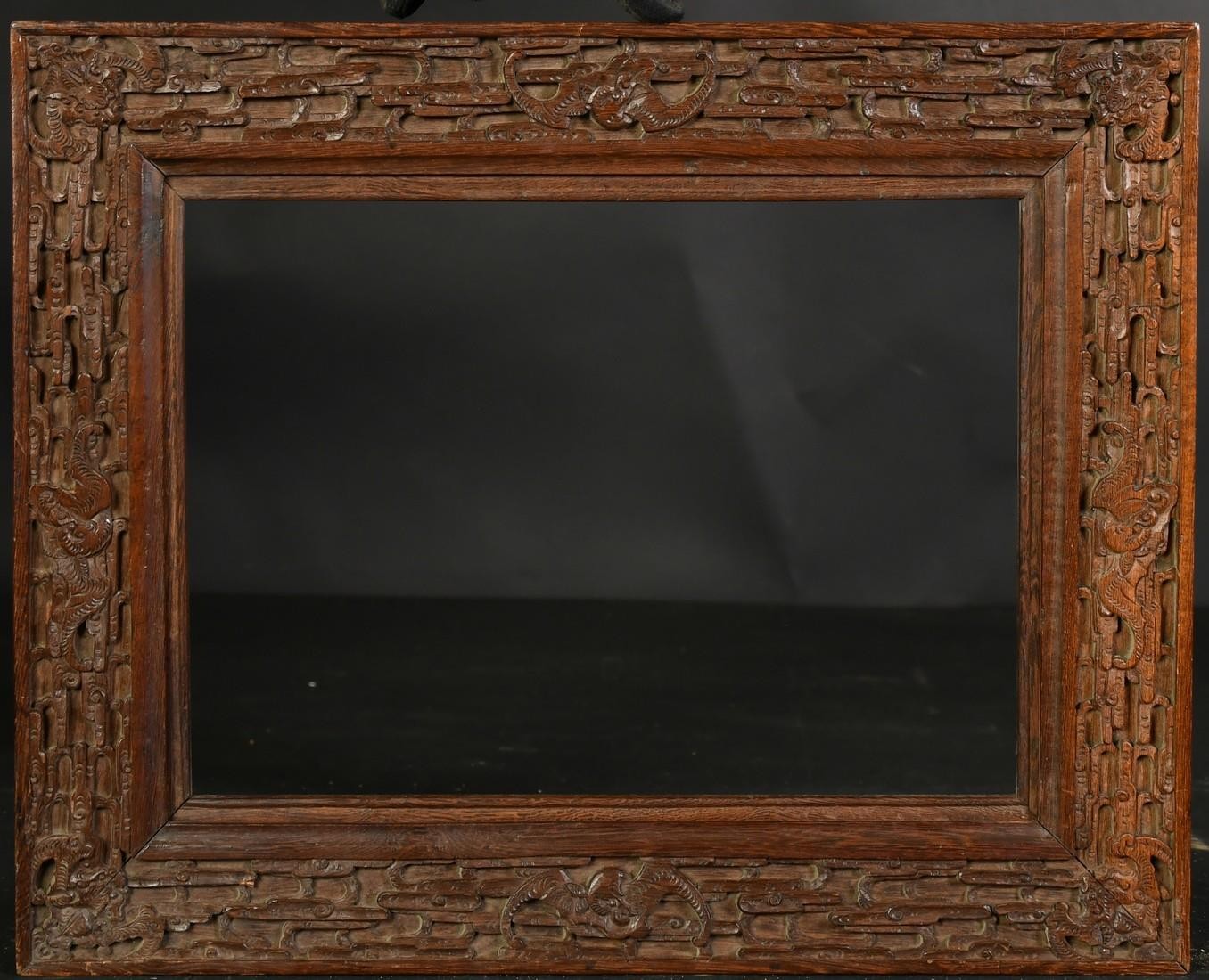 AN EARLY 20TH CENTURY CHINESE HARDWOOD FRAME, carved in an intricate design with bats and dragons, - Image 2 of 4