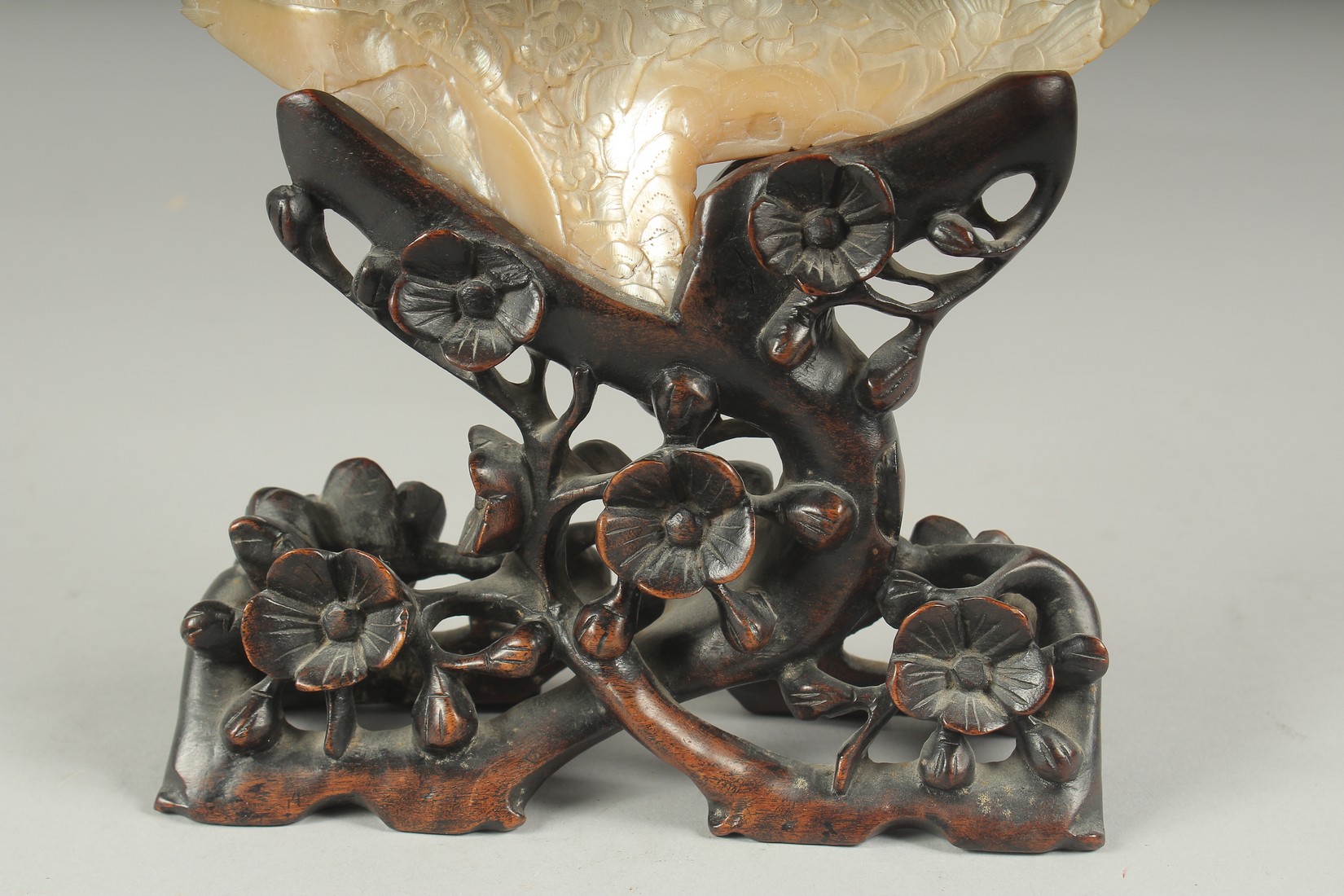 A CHINESE CARVED MOTHER OF PEARL SHELL, on a carved and pierced hardwood stand. - Image 3 of 4