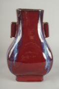A CHINESE FLAMBE GLAZE PORCELAIN TWIN HANDLE VASE, 28cm high.