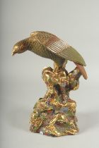 A JAPANESE GILDED PORCELAIN EAGLE UPON A ROCKY MOUND, 32cm high.