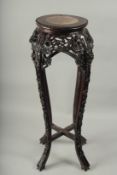 A CHINESE MARBLE INSET CARVED HARDWOOD VASE STAND, with carved and pierced floral frieze on