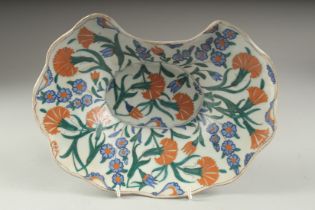 AN OTTOMAN TURKISH GLAZED POTTERY BARBER PLATE, 27.5cm wide.