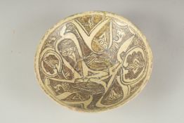 A FINE 10TH - 11TH CENTURY PERSIAN NISHAPUR POTTERY BOWL depicting two birds, 21.5cm.