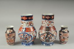 A PAIR OF JAPANESE IMARI PORCELAIN VASES, together with a pair of smaller vases, larger pair 22cm