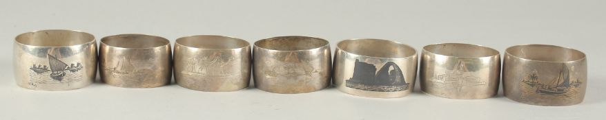 A COLLECTION OF IRAQI SILVER AND NIELLO NAPKIN RINGS, (7).