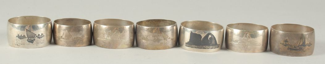 A COLLECTION OF IRAQI SILVER AND NIELLO NAPKIN RINGS, (7).