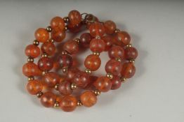 AN AMBER BEADED NECKLACE.