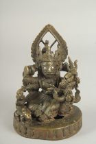 A RARE 16TH - 17TH CENTURY SOUTH INDIAN OR TIBETAN BRONZE FIGURE OF A SEATED DEITY, with silver