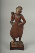 A CHINESE CARVED WOOD FIGURE AND STAND.