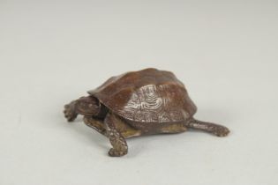 A JAPANESE BRONZE OKIMONO OF A TORTOISE, with retracting head, mark to underside, 5cm long.