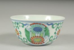 A CHINESE DOUCAI PORCELAIN CUP, decorated with floral motifs, character mark to base, 8cm diameter.