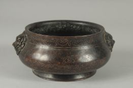 A 19TH / 20TH CENTURY CHINESE WIRE INLAID HEAVY BRONZE CENSER, with relief lion head handles, 17cm