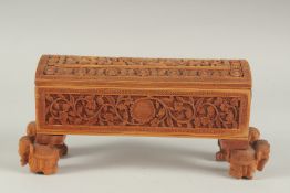 A FINE 19TH CENTURY INDIAN MYSORE CARVED SANDALWOOD BOX, standing on four carved elephant shaped