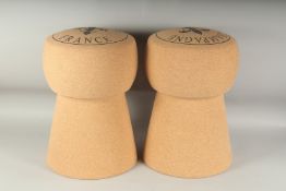 A PAIR OF CORK CHAMPAGNE STOOLS. 18ins high.