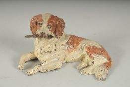 AN AUSTRIAN COLD PAINTED BRONZE DOG INKWELL carrying a quill in its mouth. 4.5Iins long.