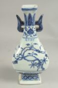A CHINESE BLUE AND WHITE TWO HANDLED VASE. 11ins high.