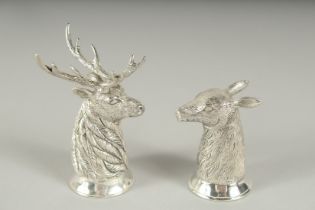 A PAIR OF .800 SILVER PLATED STAG AND DEER SALT AND PEPPERS. 7cm high.
