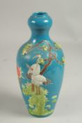 A CHINESE BLUE VASE with a stork in relief, impressed mark. 8ins high.