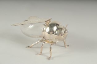 A SILVER PLATED AND GLASS HONEY BEE POT.
