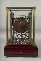 A ROLLING BALL CLOCK with 21 large chrome balls, in a glass case.