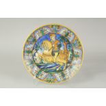 A CANTAGALLI ITALIAN POTTERY CIRCULAR CHARGER, the centre with a man on horseback. 14ins diameter,