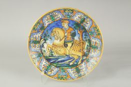 A CANTAGALLI ITALIAN POTTERY CIRCULAR CHARGER, the centre with a man on horseback. 14ins diameter,