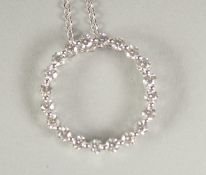 AN 18CT WHITE GOLD DIAMOND SET CIRCLE OF LIFE PENDANT AND CHAIN in a box.