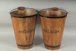 A PAIR OF BOLLINGER WOODEN TAPERING BUCKETS with metal handles. 16ins high.