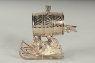 A SILVER PLATED BEAR ON A SLEDGE with a barrell.