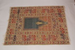 A PERSIAN PRAYER RUG, beige ground with stylised borders. 5ft 10ins x 4ft 4ins.