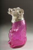 A GLASS CLARET JUG formed as a bear with silver plated head. 7ins high.