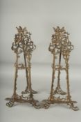 A PAIR OF ANTIQUE METAL PICTURE EASLES. 23ins high.