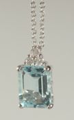 AN 18CT WHITE GOLD AQUAMARINE AND DIAMOND PENDANT on a chain, in a box.