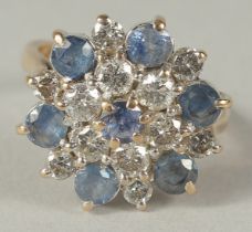 A WHITE GOLD DIAMOND AND SAPPHIRE CLUSTER RING in a box.