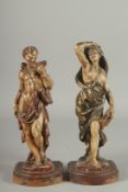 A GOOD PAIR OF 17TH - 18TH CENTURY CARVED AND POLYCHROMED WOOD FIGURES. A man playing a pan pipe and