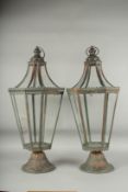 A PAIR OF METAL TAPERING LANTERNS with ring handles. 26ins high.