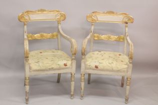 A GOOD PAIR OF REGENCY CREAM PAINTED AND GILDED ARM CHAIRS with accanthus curving drop in padded