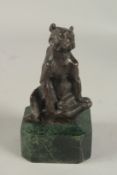 A SMALL BRONZE SEATED BEAR on a metal base. 5ins.