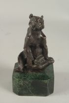 A SMALL BRONZE SEATED BEAR on a metal base. 5ins.
