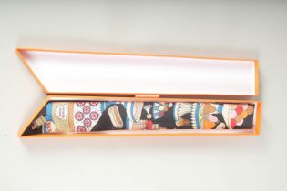 A HERMES SILK TIE in a box.