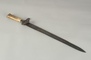 A GERMAN KNIFE with 13ins engraved blade, bone handle, in a leather sheath.