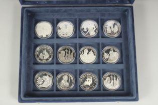 THE POPE JOHN PAUL II COIN COLLECTION. TWELVE SILVER COINS in a blue velvet case and paper cover.