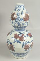 A CHINESE DOUBLE GOURD VASE painted with fruit. 12ins high.