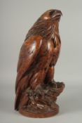 A SUPERB SWISS CARVED BLACK FOREST EAGLE with glass eyes, possibly walnut, with poker work feathers,