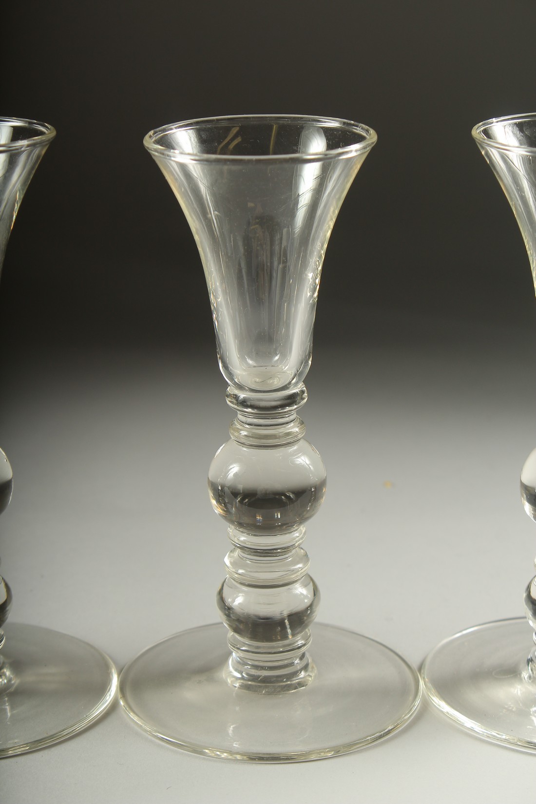 A SET OF FOUR PLAIN KNOP STEM WINE GLASSES. 7ins high. - Image 4 of 5