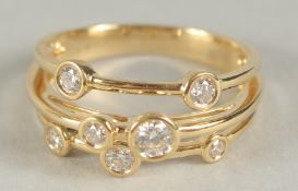 A GOOD 18CT YELLOW GOLD SEVEN STONE DIAMOND RING. Size O in a box.