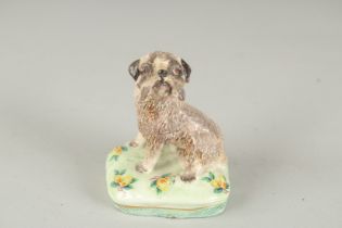 BASIL MATHEWS. A POTTERY DOG, signed. 2.75ins high.