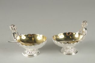 A GOOD PAIR OF SILVER PLATED CHERUB SALTS and spoons.