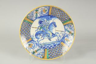 A CANTAGALLI ITALIAN POTTERY CIRCULAR CHARGER. The centre with a man on horseback in blue. 14ins
